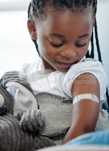 Image of Immunisations can save your childs life. an adorable little girl with a plaster on her arm after an injection.