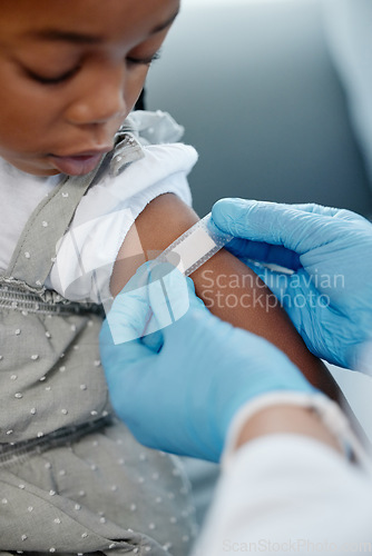 Image of Getting her routine childhood vaccination. Closeup shot of an unrecognisable doctor applying a plaster to a little girls arm after an injection.