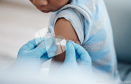 Image of Vaccines are an important means of keeping your child healthy. Closeup shot of an unrecognisable doctor applying a plaster to a little boys arm after an injection.