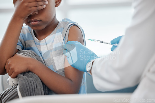 Image of Itll be over soon and then youll feel better. a little boy looking scared while getting an injection on his arm from a doctor.