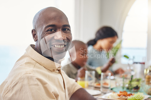 Image of Enjoying family time at dinners and meals at Thanksgiving. a man having lunch with his family.