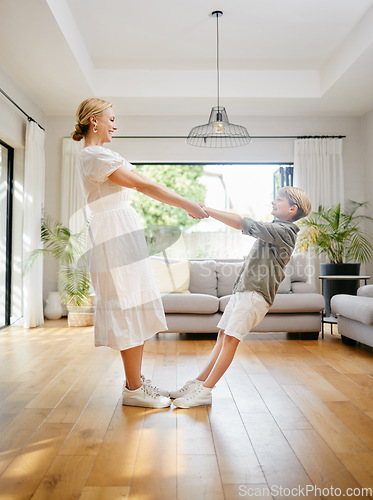 Image of Beautiful caucasian mother dancing at home with her young son. Happy mom and son sharing a dance and having fun together at home