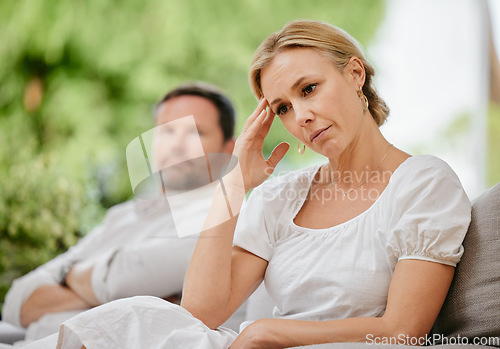 Image of Mature woman looking upset and annoyed after arguing with her husband about marriage problems. Feeling negative. This relationship could end in divorce if they continue to disagree and fight.