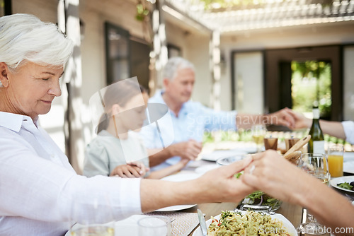 Image of Food brings us together, love keeps us together. a family saying grace while sitting together at the dining table.