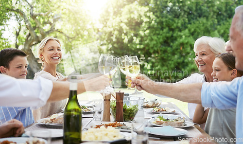 Image of When family gets together, it calls for a celebration. a family sharing a toast while enjoying a meal together.