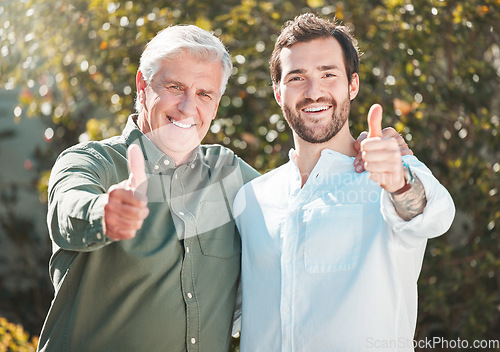 Image of Youve got our support. Cropped portrait of a handsome young man and his father gesturing thumbs up outdoors.