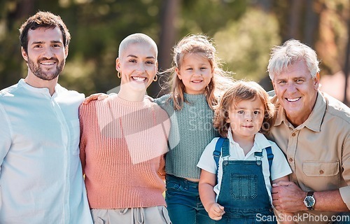 Image of Say cheese for the family portrait. a multi-generational family posing together outdoors.