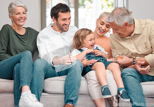 Image of Grandpa brings the giggles. a happy family bonding on the sofa at home.