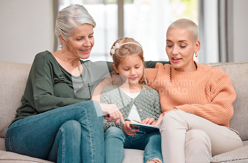 Image of We have the same taste. a mature woman bonding with her daughter and granddaughter while using a digital tablet.
