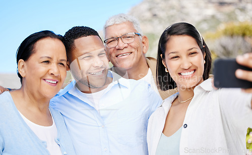 Image of Make sure to get the mountain in. a beautiful family taking a selfie together while bonding outside.