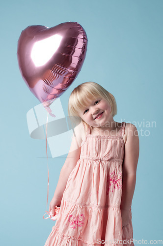 Image of Everyone deserves balloons. an adorable little girl holding a heart balloon against a studio background.