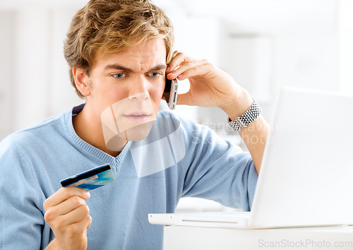 Image of The online payment system is broken. a young man making an angry phone call while making online payments.