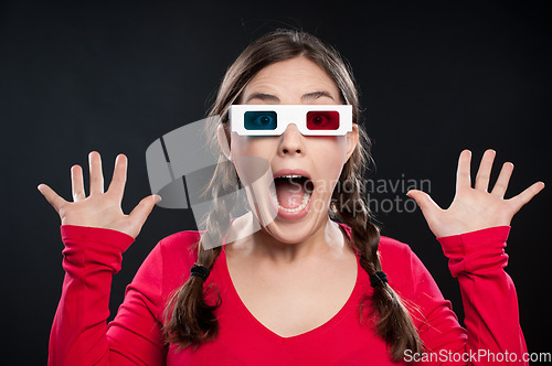 Image of What a scare that was. a young woman wearing 3D glasses against a studio background.