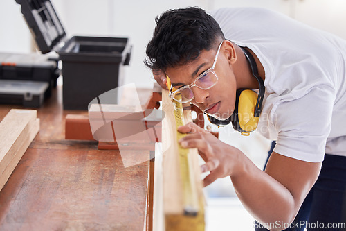 Image of A good carpenter never disappoints. a carpenter doing measurements on wood.