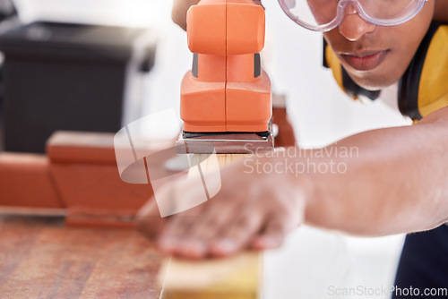 Image of I need a smooth surface. a carpenter sanding a wood project.