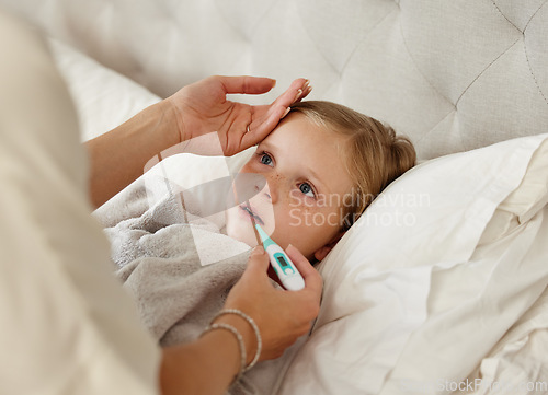 Image of For he who has health has hope. a woman taking her little girls temperature with a thermometer in bed at home.