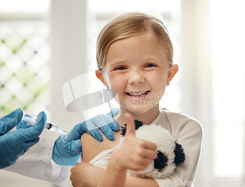 Image of Visiting the doctor can be fun. a doctor giving a little girl an injection during a checkup at home.