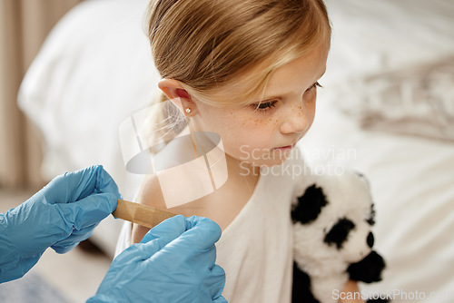 Image of Precious patient. an unrecognizable doctor applying a cotton ball to a patients arm at home.