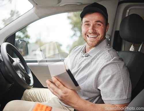 Image of Just double checking my route. Cropped portrait of a handsome young delivery man using a tablet while sitting in his van.