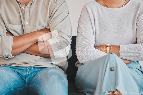 Image of Im not going to put up with you anymore. Closeup shot of an unrecognisable couple sitting with their arms crossed during an argument at home.