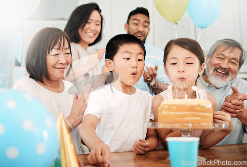 Image of Celebrate and look forward to the coming year. an adorable little boy and girl celebrating a birthday with their family at home.