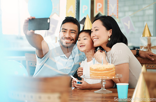 Image of Cherish all your happy moments. a happy family taking selfies while celebrating a birthday at home.