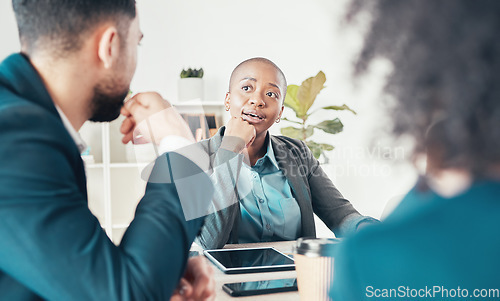 Image of Im listening. an attractive young businesswoman sitting and having a meeting with her colleagues in the office.