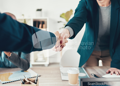 Image of Youve got yourself a deal. two unrecognisable businesspeople shaking hands during a meeting in the office.