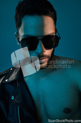 Image of Whats cooler than confidence. Conceptual shot of a stylish young man posing in studio against a blue background.