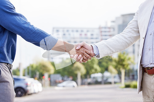 Image of It takes two flints to make a fire. two unrecognizable businesspeople shaking hands.