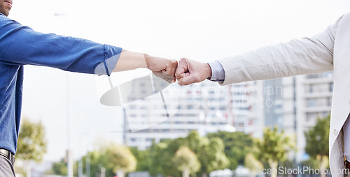 Image of Great things in business are never done by one person. two unrecognizable business people fist bumping outside.