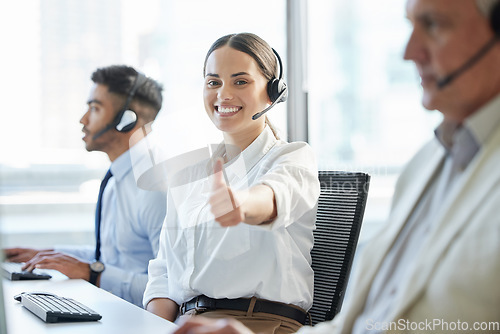 Image of Thank you for calling. a young woman showing thumbs up while working in a call center.