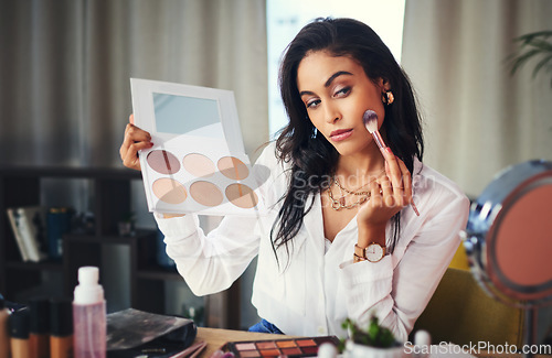 Image of Ill show you how to get your glow on. a influencer recording a makeup tutorial for her blog at home.