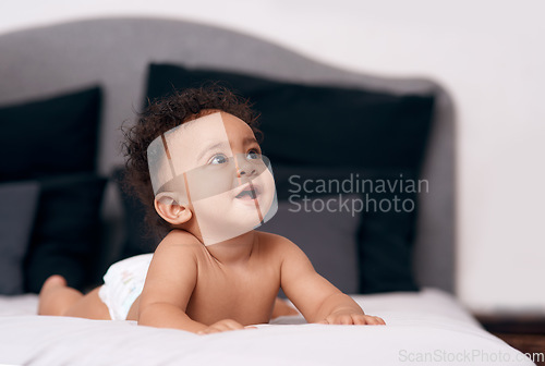 Image of Youre never too little to dream big. an adorable baby boy on the bed at home.