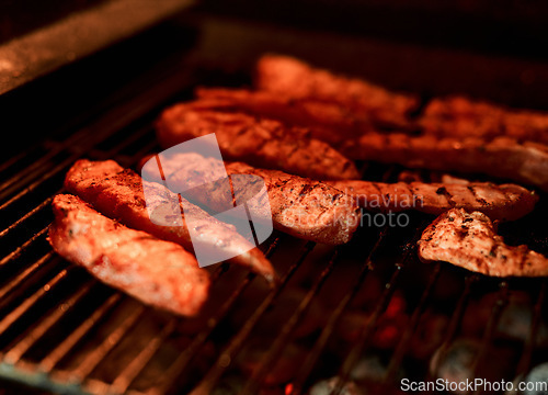 Image of That smokey, grilled taste is the best. Closeup shot of meat being barbecued on a grill.