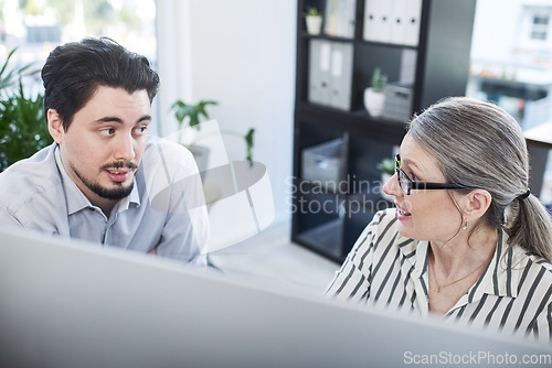 Image of Making plans that will ensure they succeed. High angle shot of two businesspeople working together on a computer in an office.