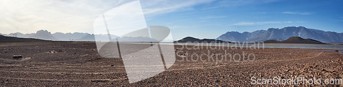 Image of Water saves lives. a desolate landscape during the day with a small dried out dam in the middle.