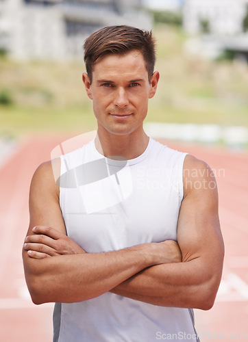 Image of Ready to do this. Portrait of a determined looking athlete standing on the track.