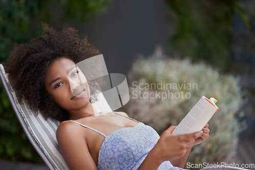 Image of Theres nothing like a good book and sunshine. an attractive ethnic female with a book outdoors.