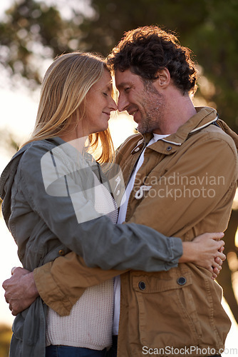 Image of Still very much in love. A cropped shot of a happy affectionate couple standing outdoors at twilight.