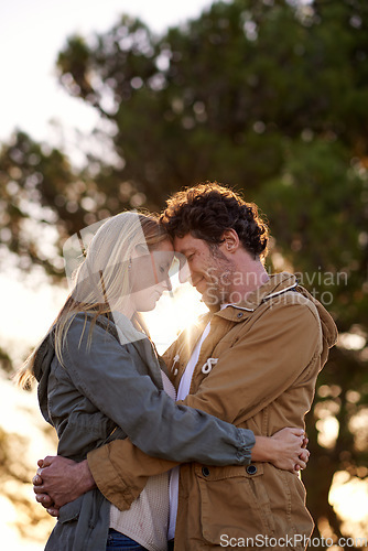 Image of Safe in your arms. A cropped shot of a happy couple standing together affectionately outdoors.