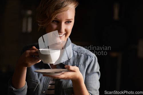 Image of Everythings better with tea. an attractive young woman drinking tea in her kitchen.