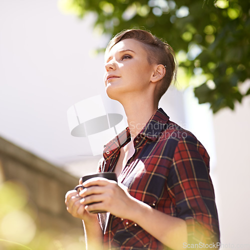 Image of What a beautiful day. A cropped shot of a beautiful young woman drinking coffee in her garden.