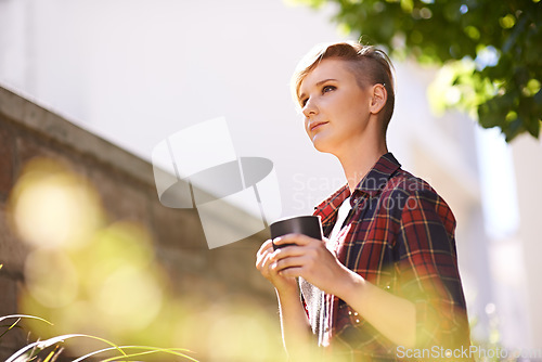 Image of Coffee breaks in my garden. A cropped shot of a beautful young woman drinking coffee in her garden.