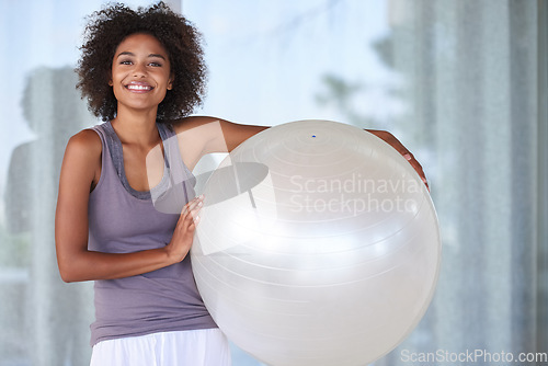 Image of Nothing beats the exercise ball. Cropped portrait of an attractive young woman standing with an exercise ball.