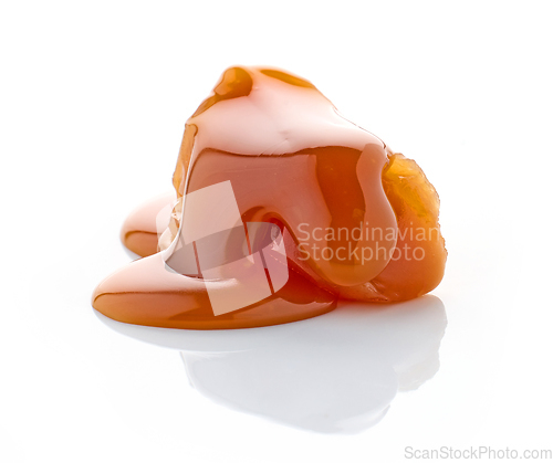 Image of caramel candy with melted caramel sauce