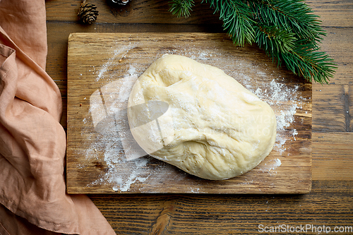 Image of dough on wooden cutting board