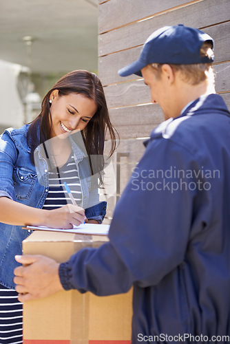 Image of Its always exiting to receive a package. A friendly delivery man delivering a package to a young woman.