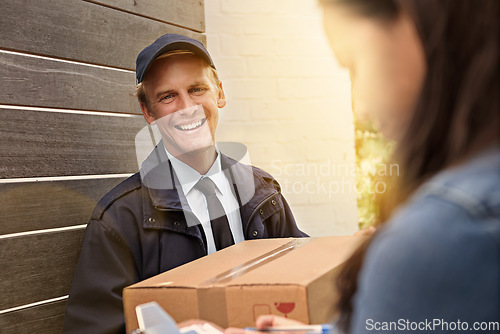 Image of Ive got your package. a young man making a delivery to a woman at her home.