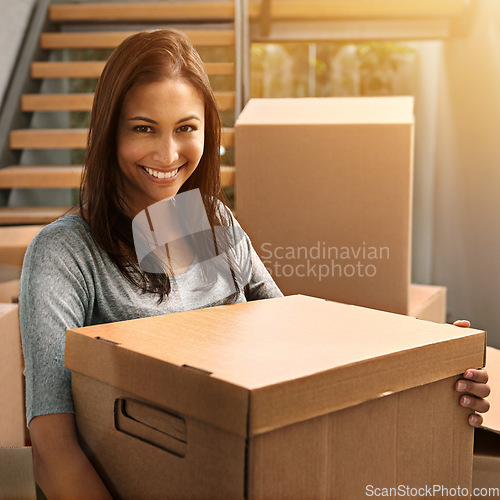 Image of Moving in and moving up. Cropped portrait of a young woman moving into her new house.